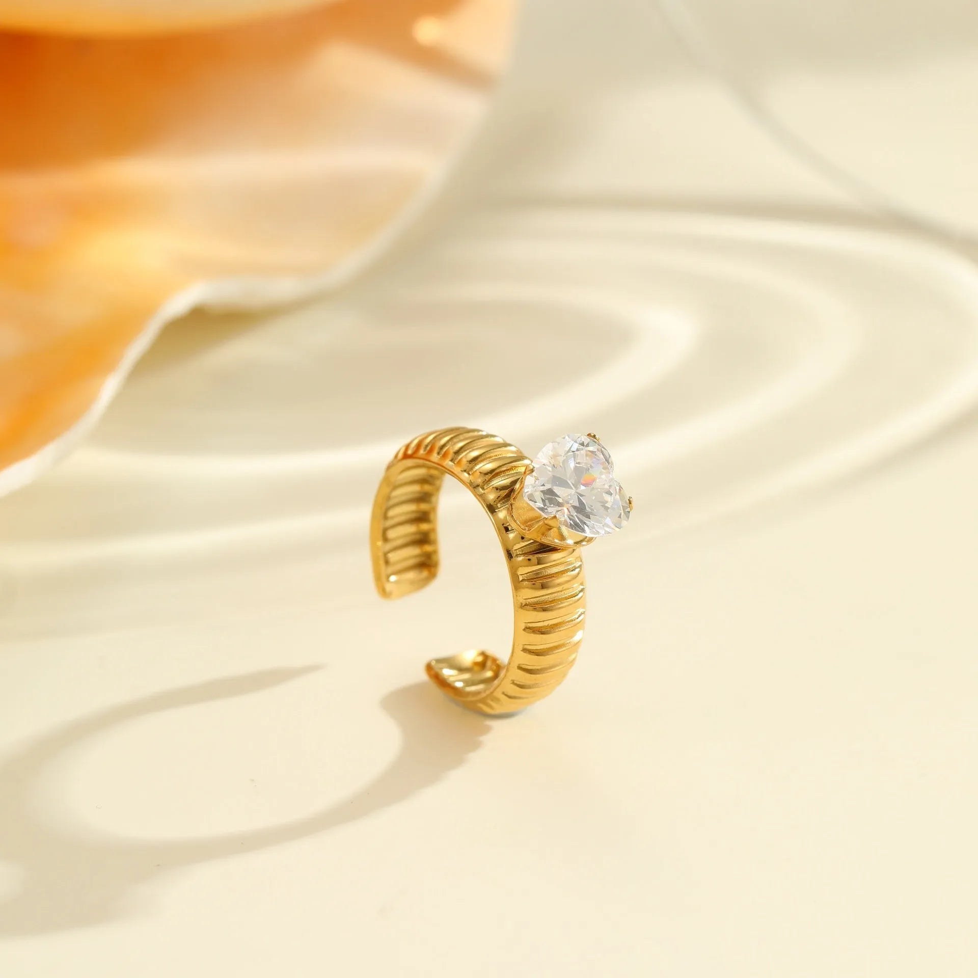 Stainless steel women's ring with gold electroplating and zircon details in geometry design