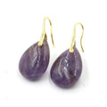 A pair of geometric water drop earrings made from crystal, shown in one of nine available colours like amethyst or obsidian.