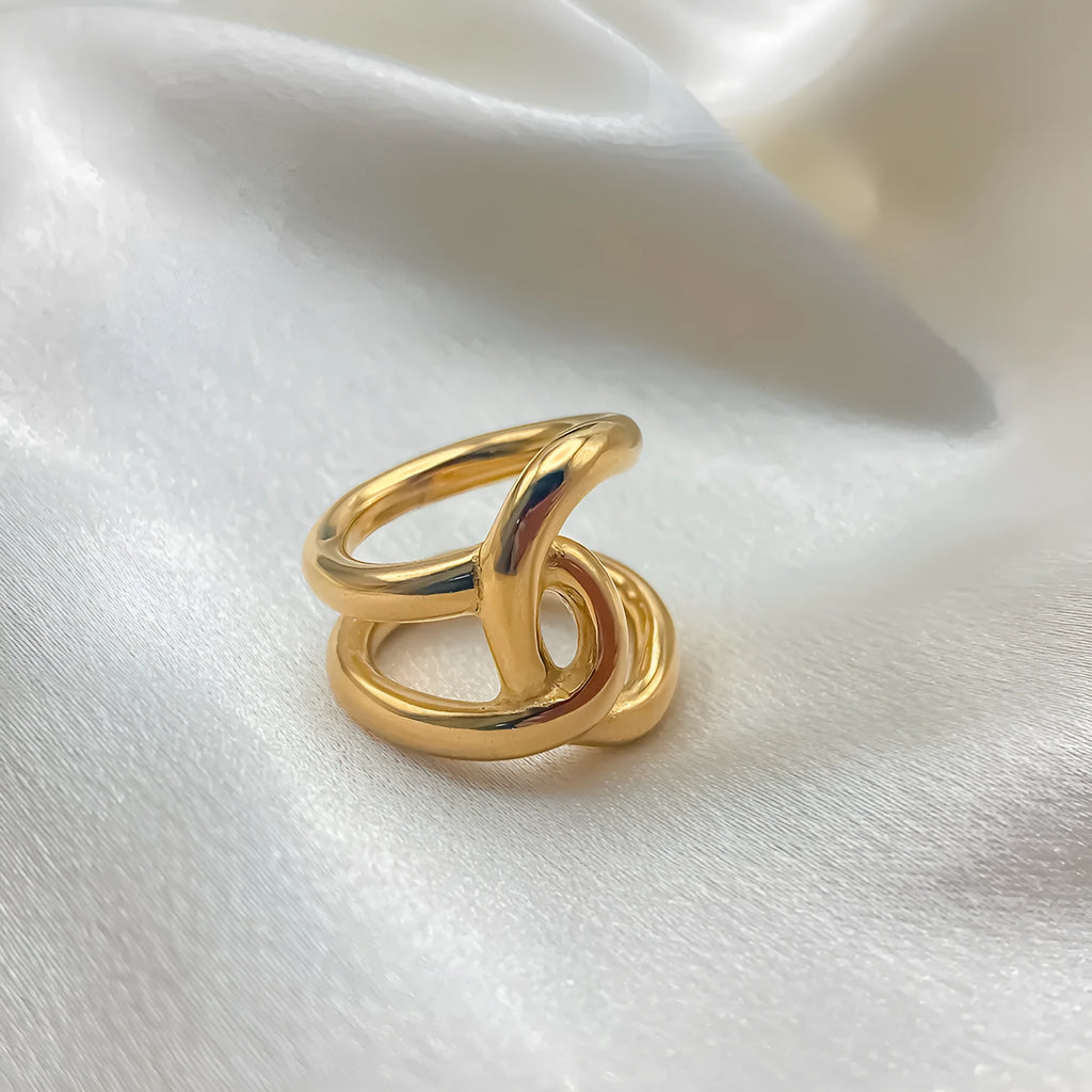Women's adjustable stainless steel ring with knotted geometric design in gold or steel colour.