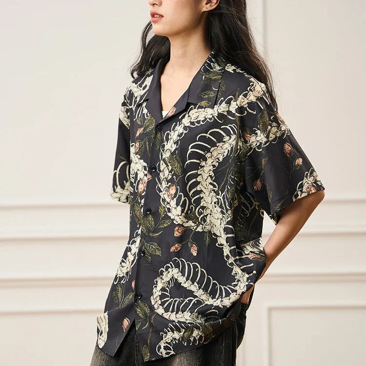 Short sleeve loose-fit shirt with a Cuban collar and a printed snake bone floral pattern.