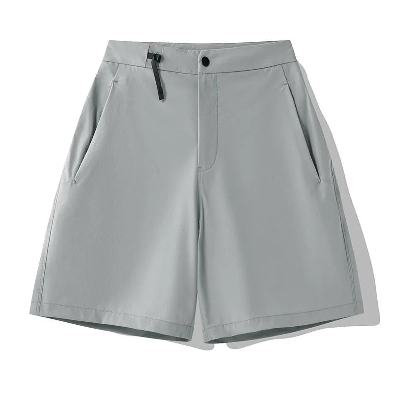 Men's solid colour quick-dry sports shorts with elastic waistband on a grey background.