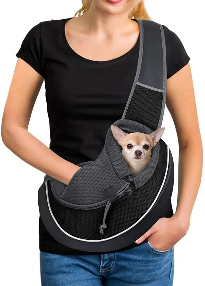 Women carrying black pet crossbody bag with small dog inside, Oxford material with drawstring closure