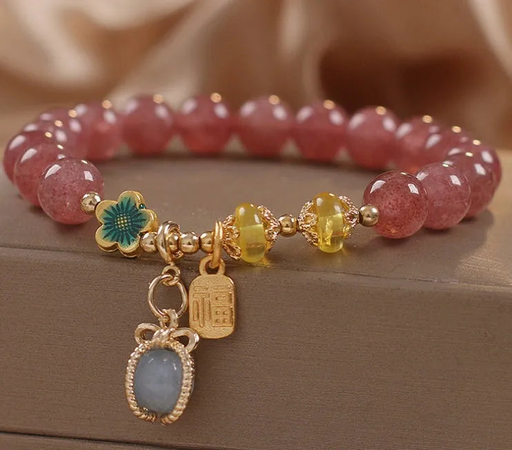 Red strawberry quartz beaded bracelet with alloy metal and rhinestone details