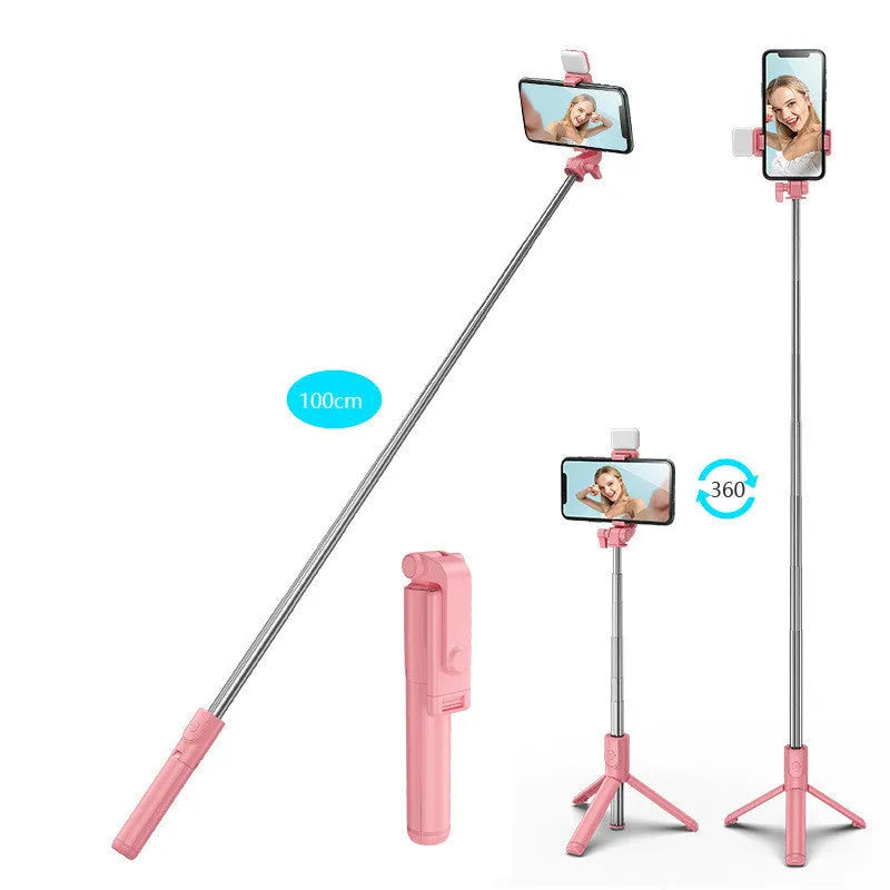 Black Bluetooth selfie stick with extended tripod legs and a phone mounted in its 360-degree rotating holder.