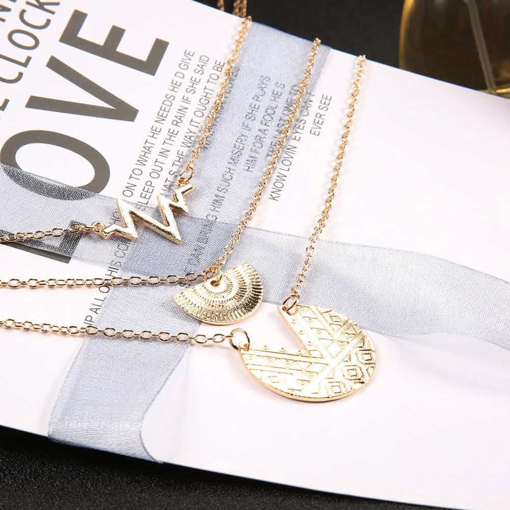 Gold multi-layer round alloy necklace with electroplated finish on white background