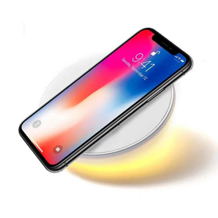 White 10W wireless charging pad with digital clock display and three control buttons.