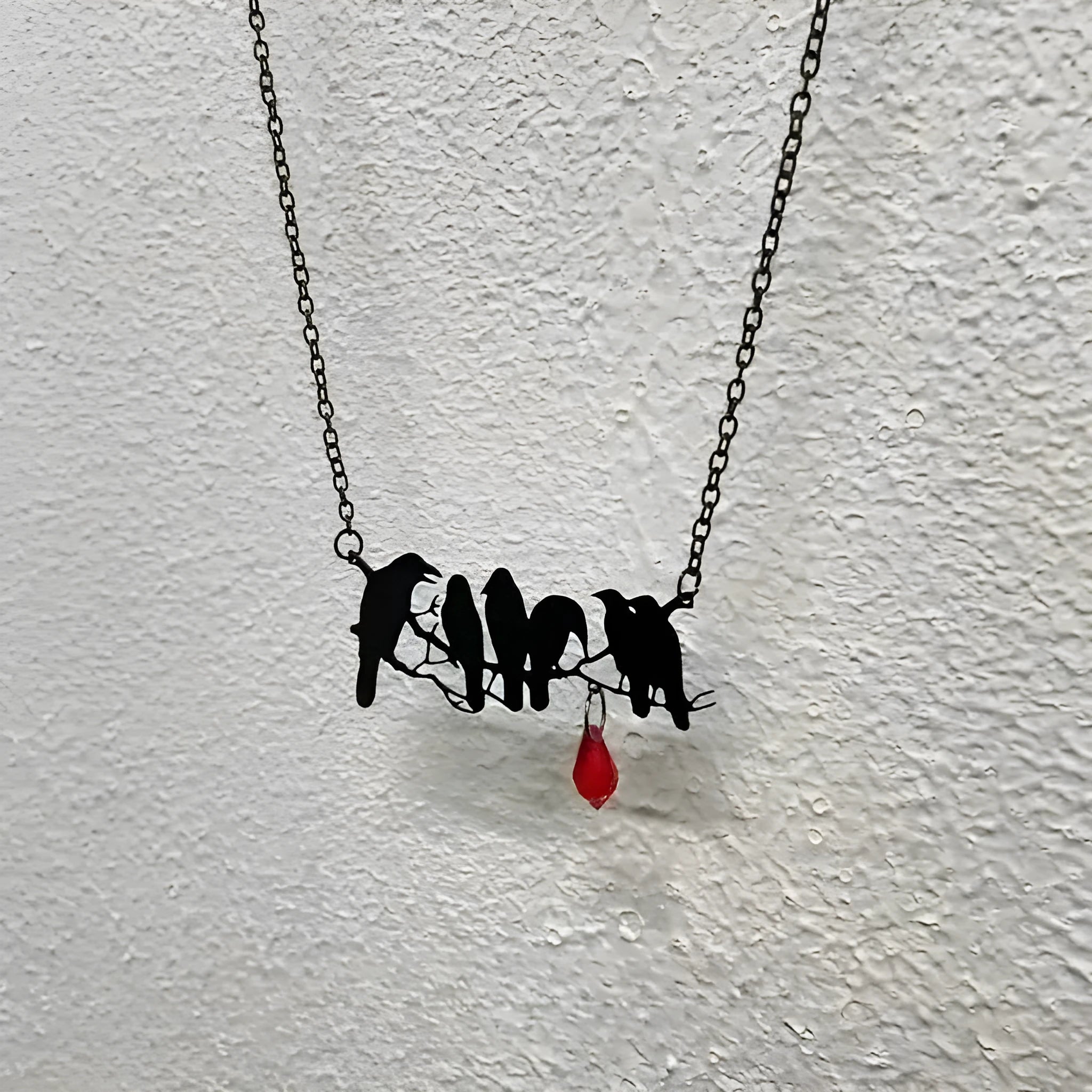 Black gothic style crow bird pendant on a cross chain necklace