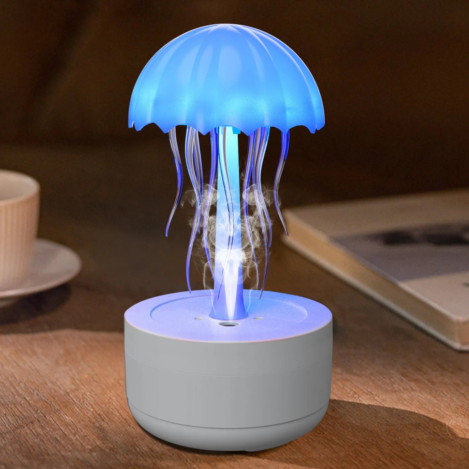 White jellyfish-shaped desktop humidifier and essential oil diffuser with colourful night light on.