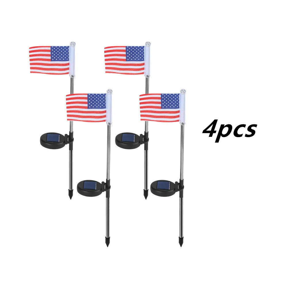 Solar-powered garden flag light displaying either American or British flag design with stainless steel pole and solar panel