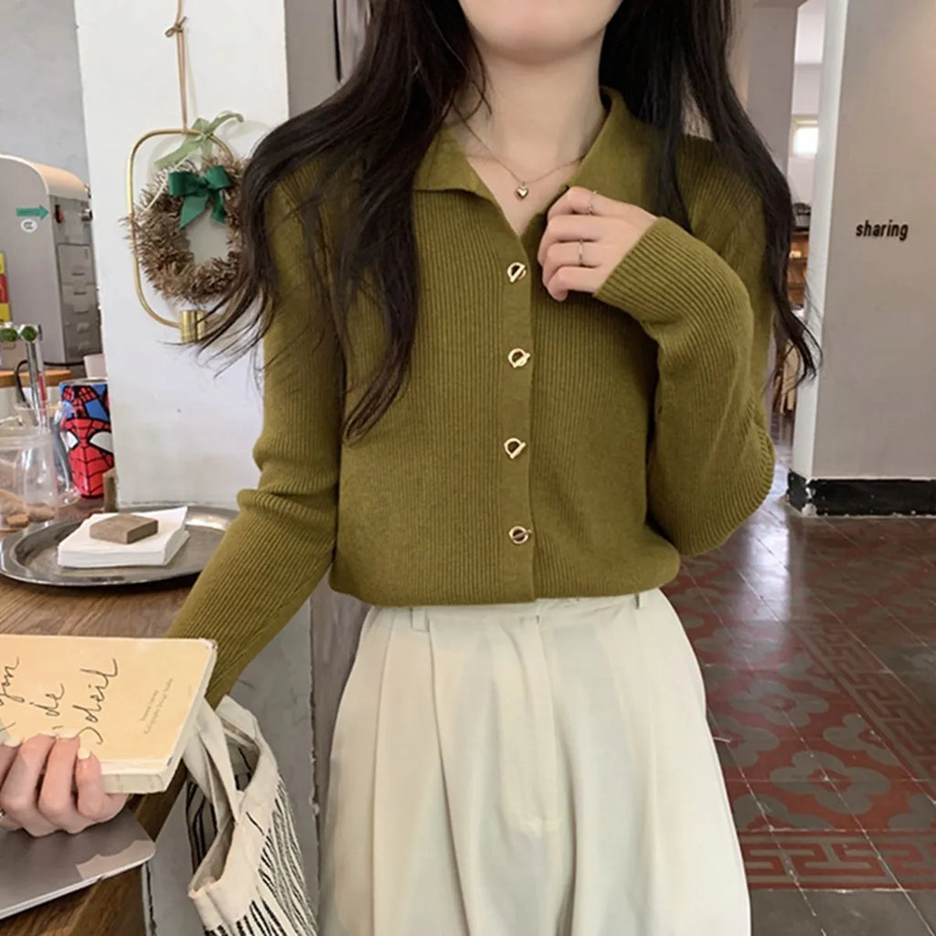 Long-sleeved loose knitted cardigan top in viscose fibre, shown in a neutral colour on a hanger.
