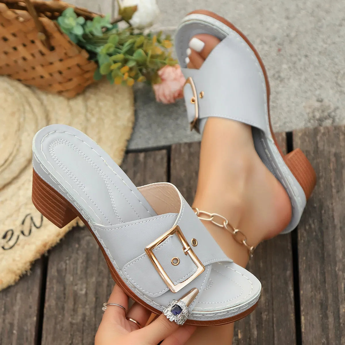 Women's retro chunky heel slippers with a metal buckle in black and light blue colours.