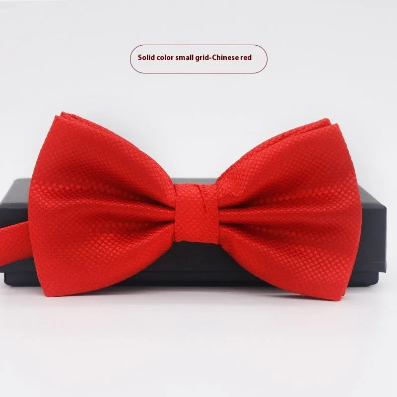 Men's flat head style polyester bow tie in a solid colour, shown with adjustable neck strap.