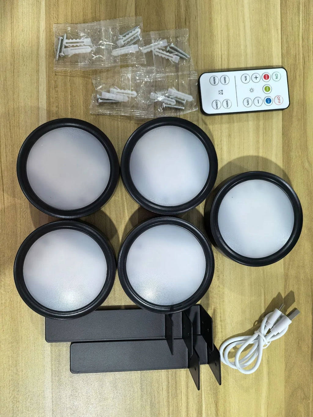Wireless rechargeable LED painting lamp with magnetic belt attached to a metal frame, remote control nearby.