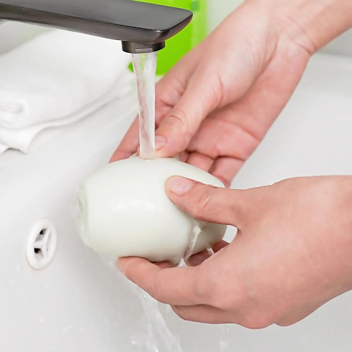 Green and white reusable gel lint roller balls for pet hair removal on fabrics