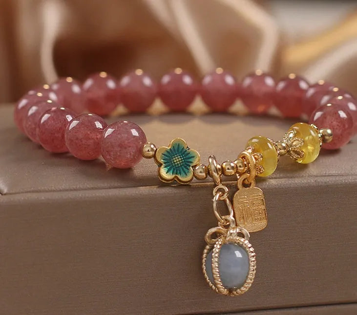 Red strawberry quartz beaded bracelet with alloy metal and rhinestone details