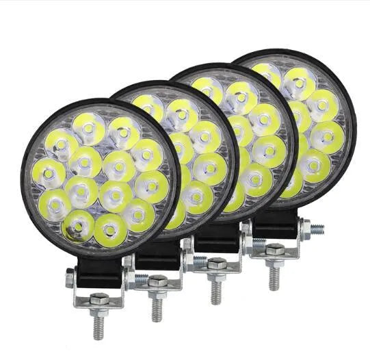 White LED mini round auxiliary work light with aluminium housing for vehicle mounting.