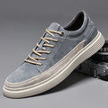 Men's grey casual skate shoes with pigskin upper and rubber sole showing lace-up front design