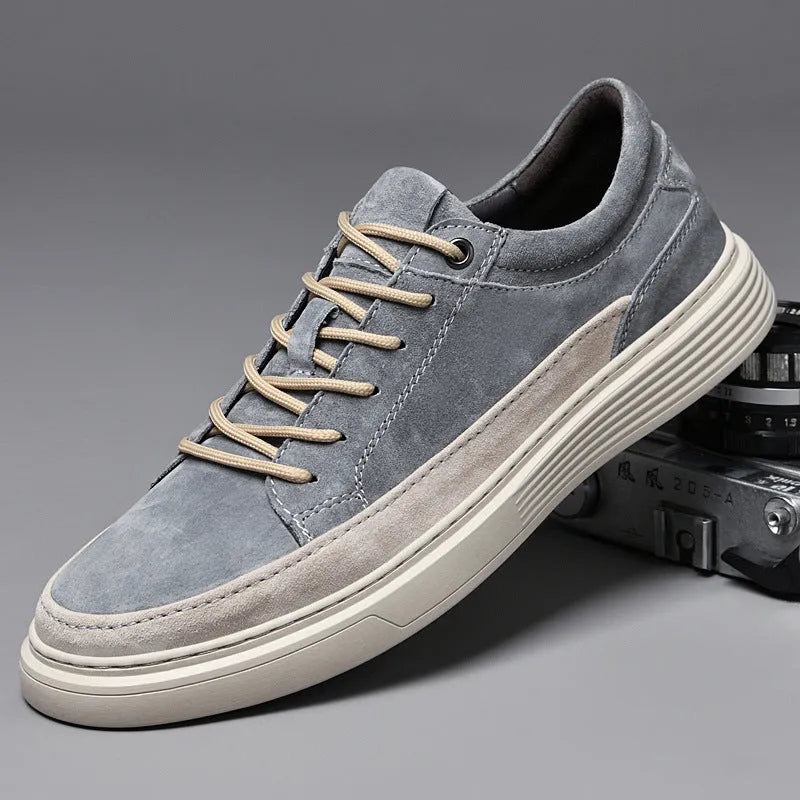 Men's grey casual skate shoes with pigskin upper and rubber sole showing lace-up front design