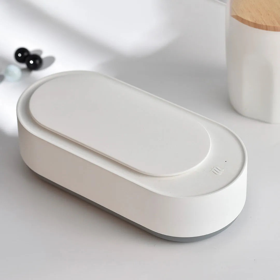 White portable ultrasonic cleaning machine with a stainless steel tank for jewellery and glasses.