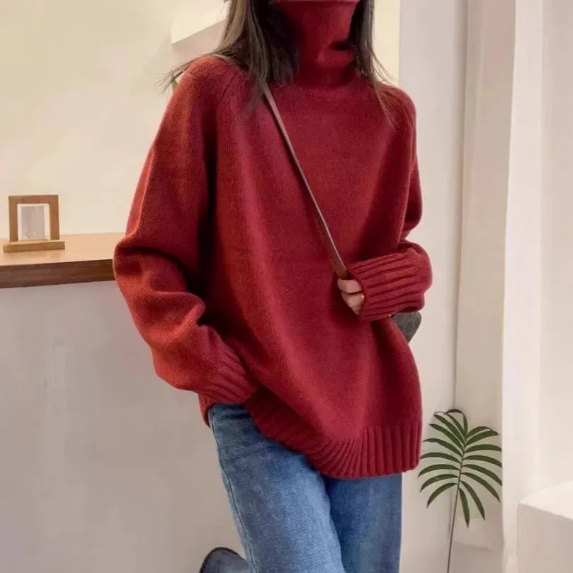 Women's loose thick turtleneck sweater with a textured 3D curling collar in a red solid colour.