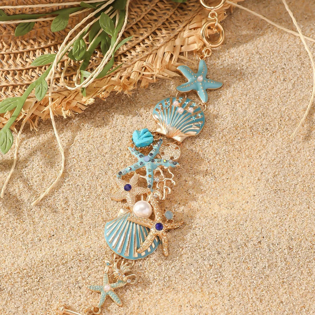 Women's alloy bracelet with a rhinestone-studded boat anchor and starfish charm in blue, red, or turquoise.