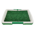 Green synthetic grass dog toilet training tray with plastic base and absorbent pad layer.