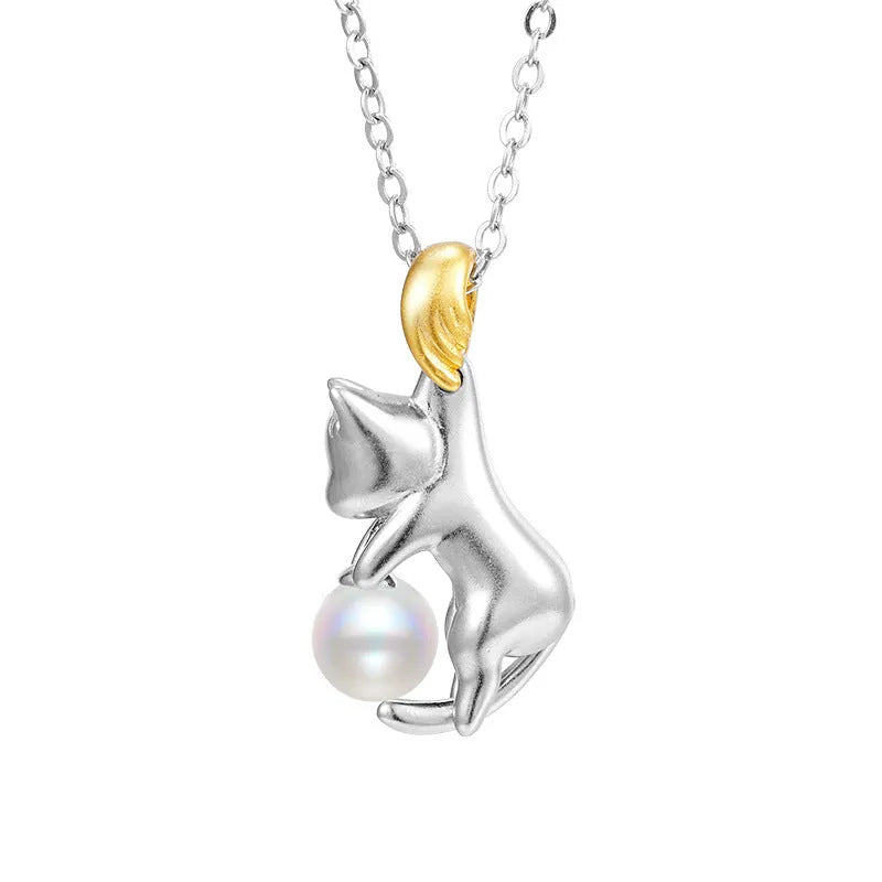 Close-up of a sterling silver cat charm clavicle chain necklace on a model.