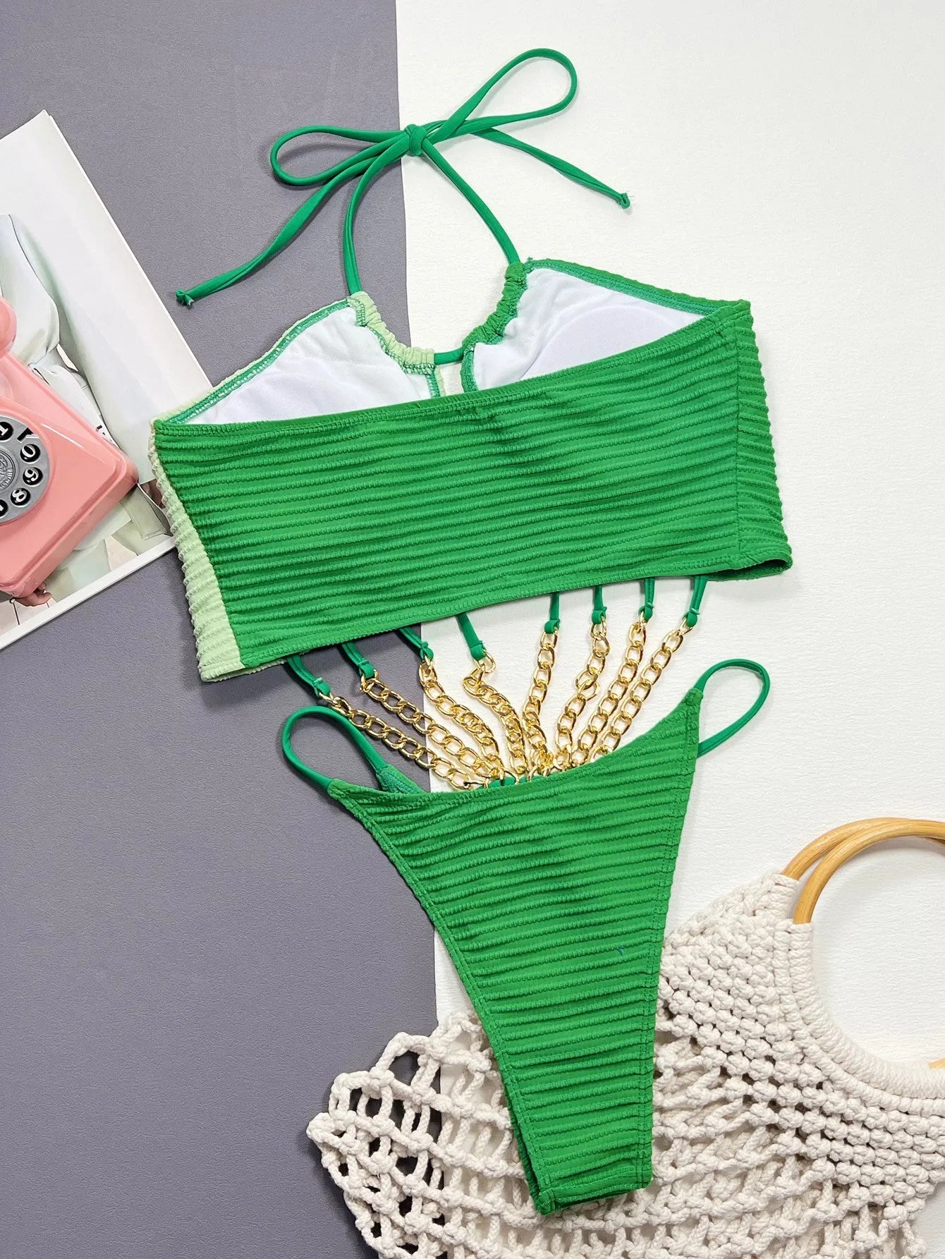 Green solid-colour one-piece swimsuit for women on a mannequin, showing the front design.