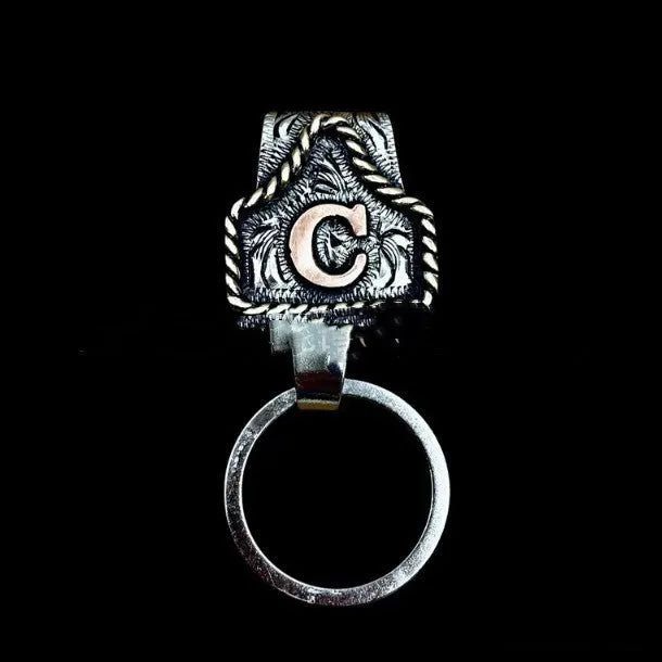 Handmade stainless steel cow tag belt key holder with engraved number plate on a split ring.