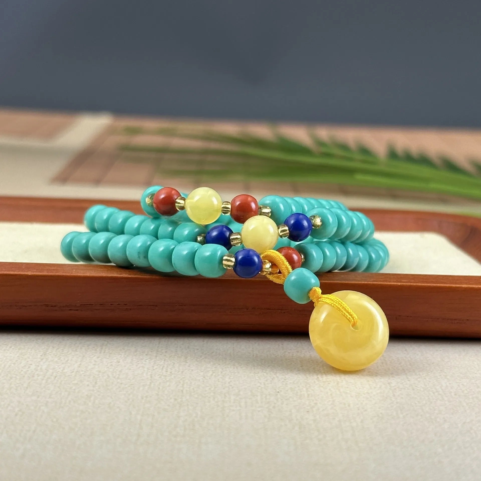 Hand-woven turquoise mesh flower lucky pendant on an adjustable ball bead necklace chain.