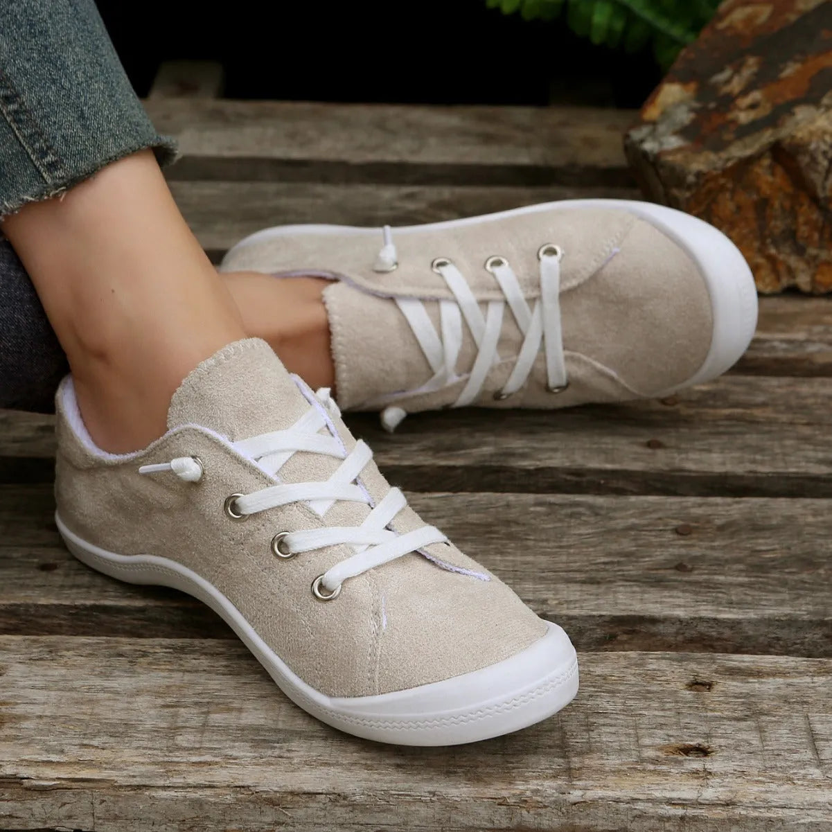 Women's creamy white low-top casual sneakers with fabric upper and rubber sole