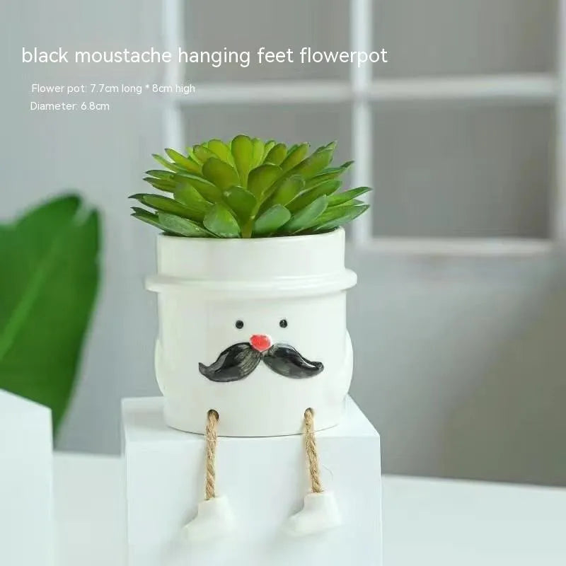 Cartoon style ceramic hanging foot flowerpot for succulent plants on a desktop.