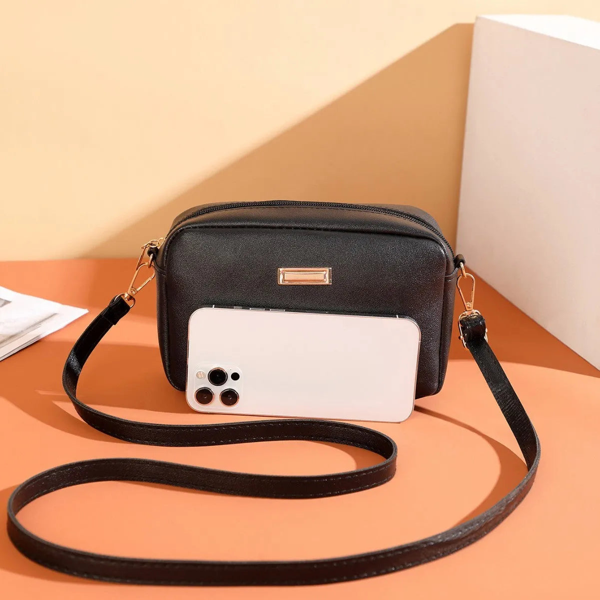 Women's solid colour PU leather shoulder bag with three-dimensional pocket and square shape.