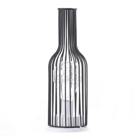 Minimalist hollow iron table lamp in red wine glass style on a wooden desk.