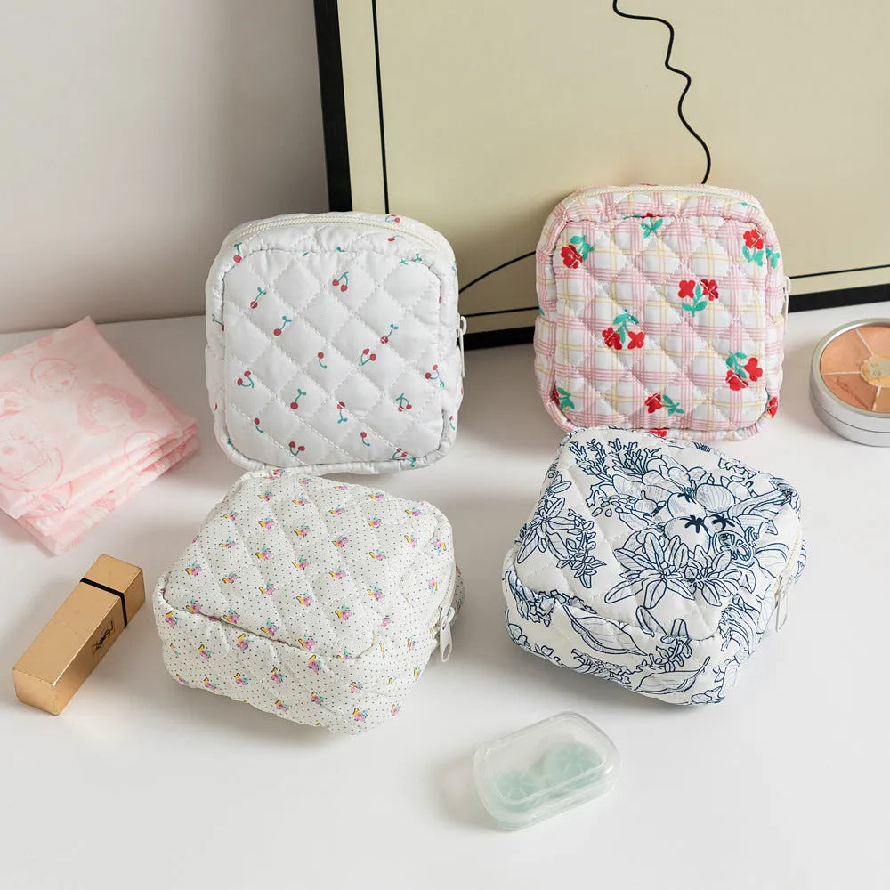 Women's key storage bag in floral polyester with sewing thread details, showing multiple colour and pattern options