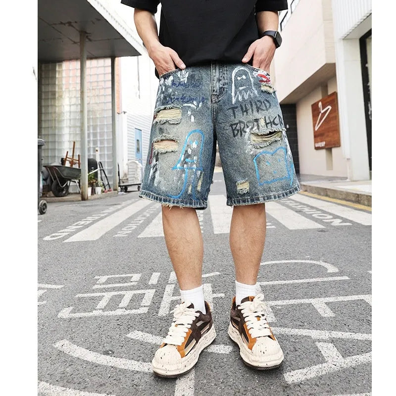 Men's blue ripped denim jeans shorts with graffiti print and straight leg design