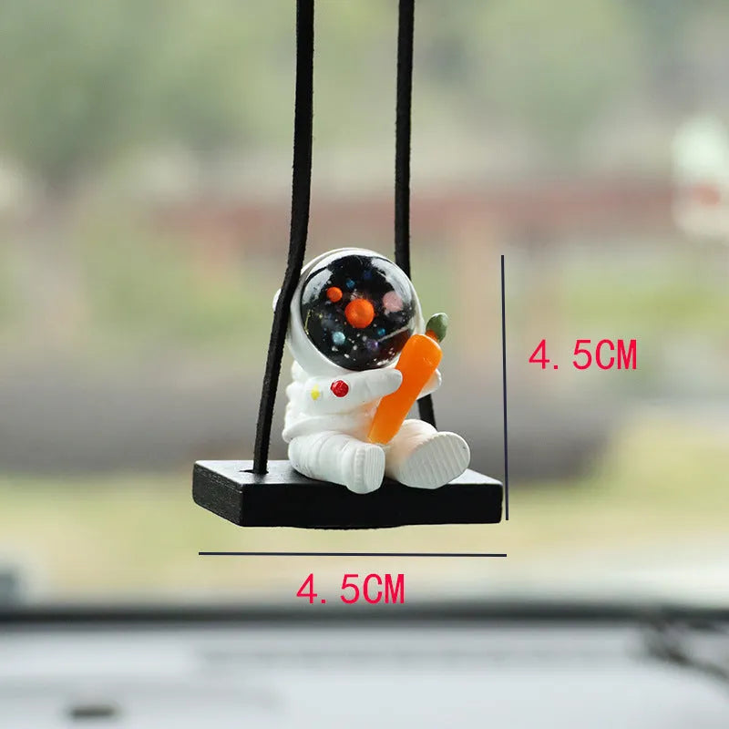 Resin astronaut car pendant in one of five cartoon colour designs