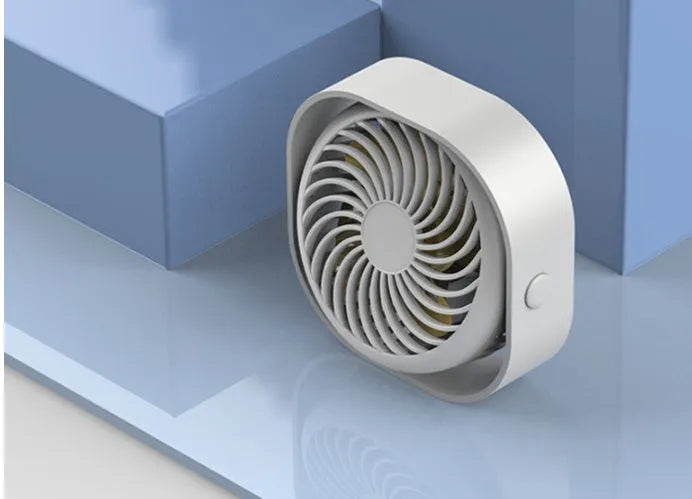 USB desk fan with rotating head in modern alarm clock design on desk