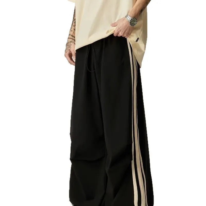 Black high-waisted wide-leg polyester climbing trousers for men laid flat.
