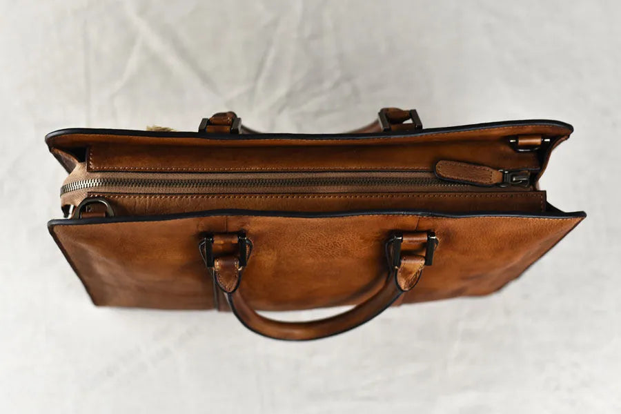 Men's brown leather horizontal business handbag with zip opening showing 14-inch size
