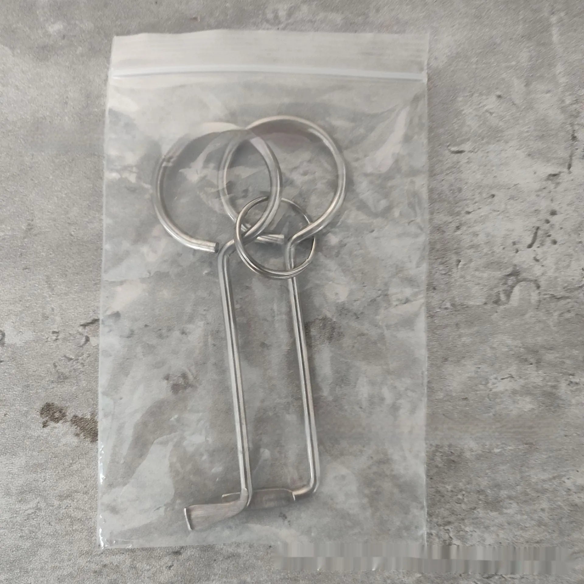 Two identical silver alloy steel wrench tools from a portable household repair set.