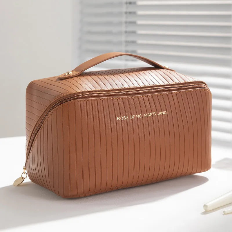 Vertical pattern pillow makeup bag in cubic design measuring 22.5cm height with travel storage capacity