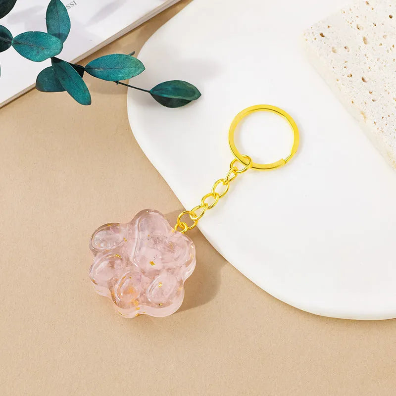 Natural crystal cat's paw keychain pendant in assorted gemstone colours on a keyring.
