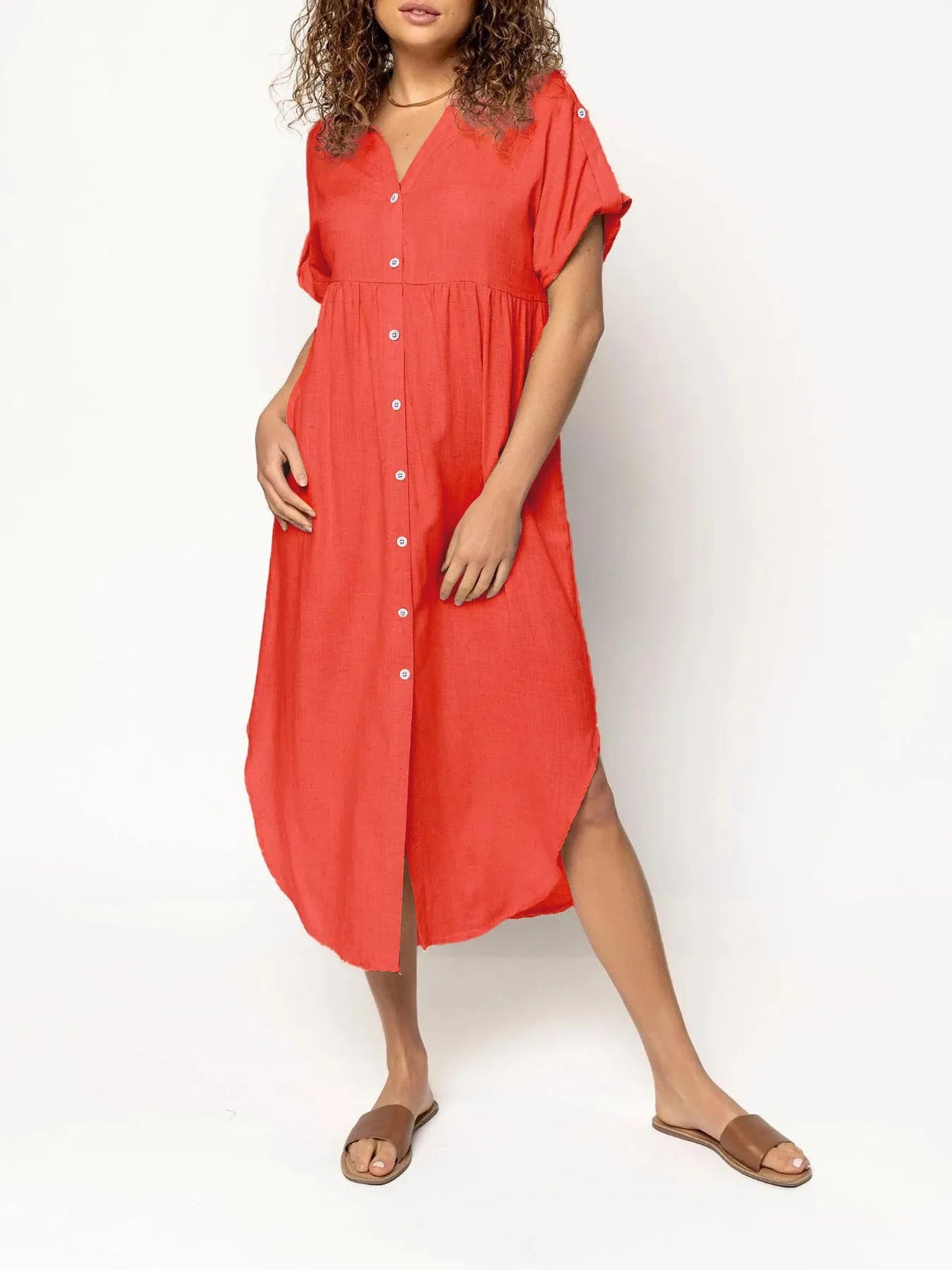 A loose-fitting, mid-length casual dress with button detail on the front, shown in a solid colour.