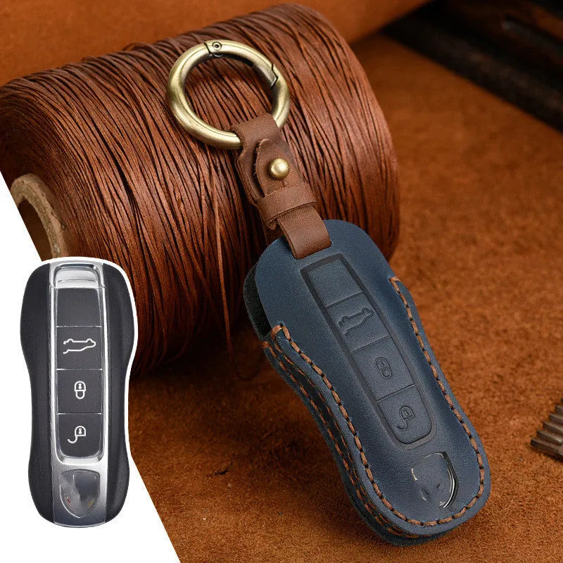 Brown leather Porsche key case with retro bag buckle holding three car keys