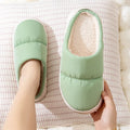 Down cotton couple slippers with artificial leather upper and non-slip rubber soles in multiple colour options