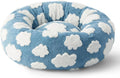 Round plaid-patterned dog bed on a floor, shown in a blue and white colour variant.