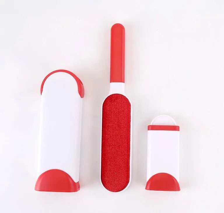Blue reusable pet hair removal brush with a self-cleaning base, placed on a grey sofa.