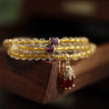 Handmade gold rutilated quartz bracelet with Chinese style hanging chopsticks and ruby quartz charm