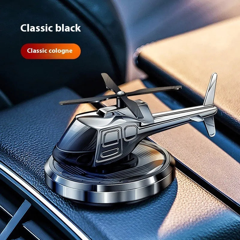 Silver metal solar helicopter car air freshener ornament rotating on dashboard